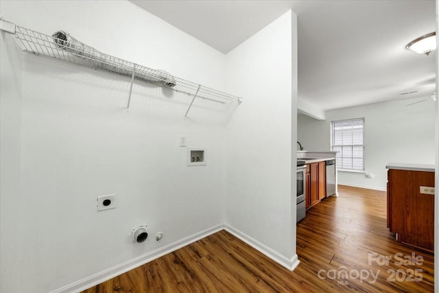 clothes washing area featuring hookup for a washing machine, gas dryer hookup, dark wood finished floors, electric dryer hookup, and laundry area