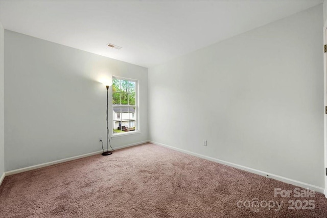 carpeted spare room with baseboards and visible vents