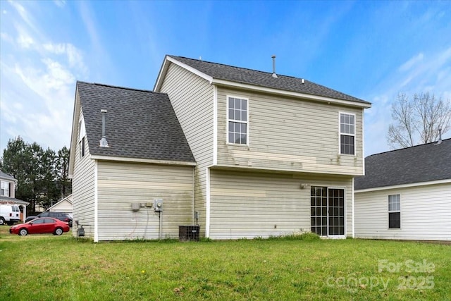 back of property featuring cooling unit and a yard