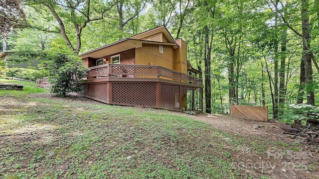 back of house with a deck