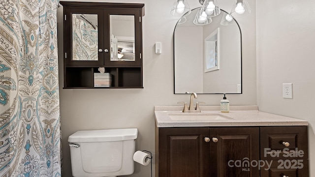 full bath featuring vanity, toilet, and a chandelier
