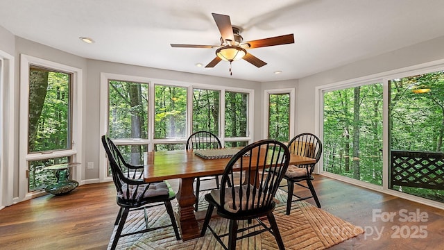 sunroom with baseboards, recessed lighting, and wood finished floors