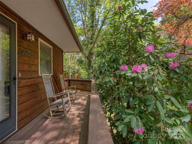 wooden terrace featuring covered porch