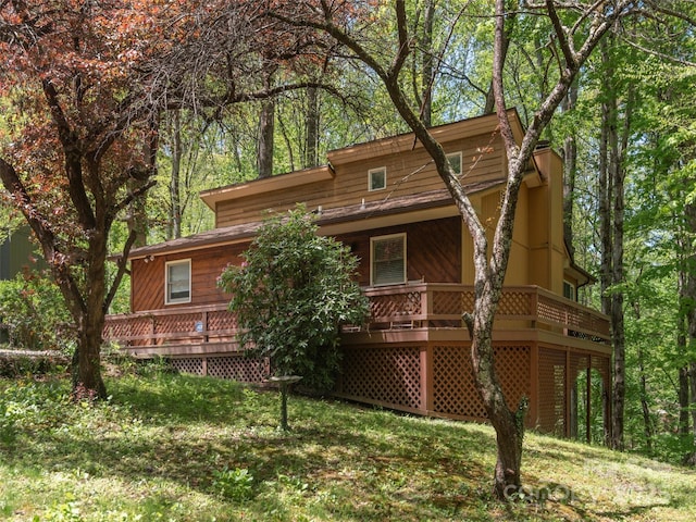 rear view of house featuring a wooden deck