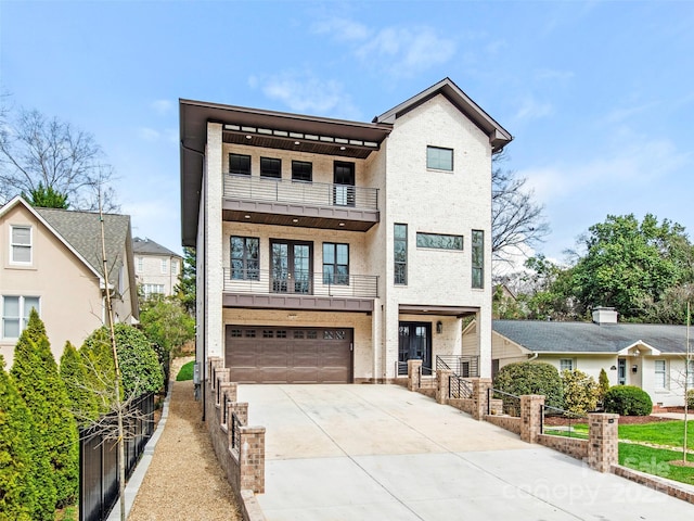 2909 Hanson Dr, Charlotte, NC 28207 - view of front facade featuring a garage, fence, a balcony, french doors, and driveway