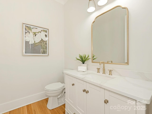 2909 Hanson Dr, Charlotte, NC 28207 - half bath with toilet, vanity, wood finished floors, and baseboards