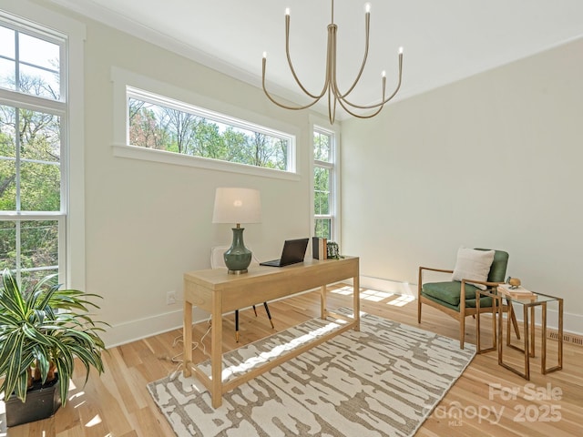 2909 Hanson Dr, Charlotte, NC 28207 - office with a notable chandelier, baseboards, crown molding, and wood finished floors