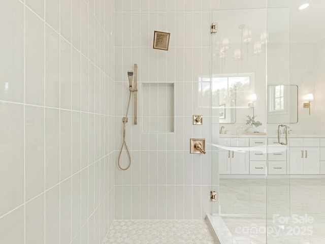 2909 Hanson Dr, Charlotte, NC 28207 - full bathroom featuring a tile shower, double vanity, and a sink