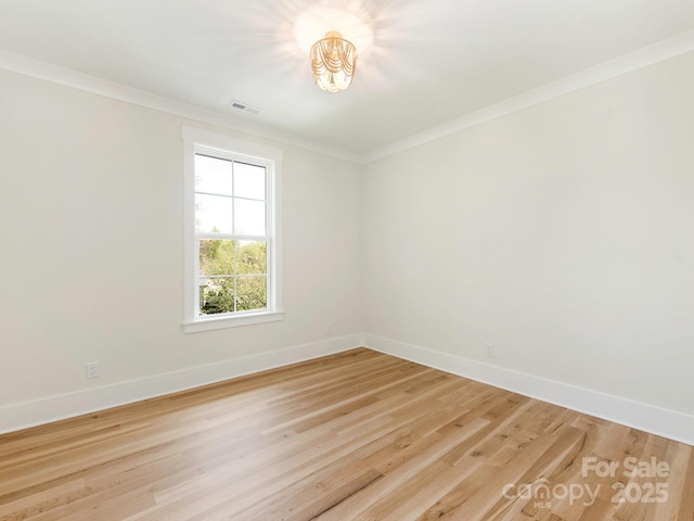 2909 Hanson Dr, Charlotte, NC 28207 - spare room with light wood finished floors, baseboards, ornamental molding, and visible vents