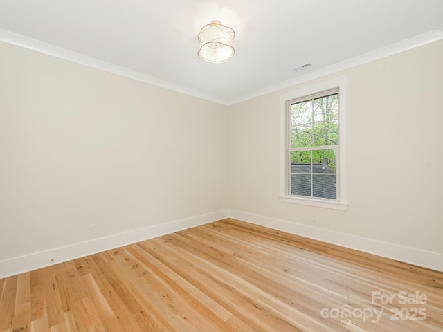 2909 Hanson Dr, Charlotte, NC 28207 - empty room featuring crown molding, visible vents, baseboards, and light wood-type flooring