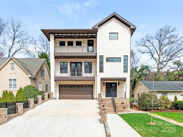 2909 Hanson Dr, Charlotte, NC 28207 - view of front of property with a balcony, a garage, brick siding, french doors, and driveway