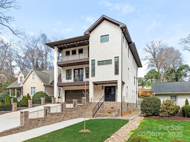 2909 Hanson Dr, Charlotte, NC 28207 - view of front of home with concrete driveway, a balcony, brick siding, a garage, and fence