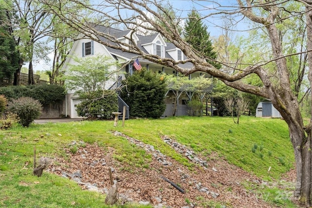 view of yard with a shed, an outdoor structure, and an attached garage