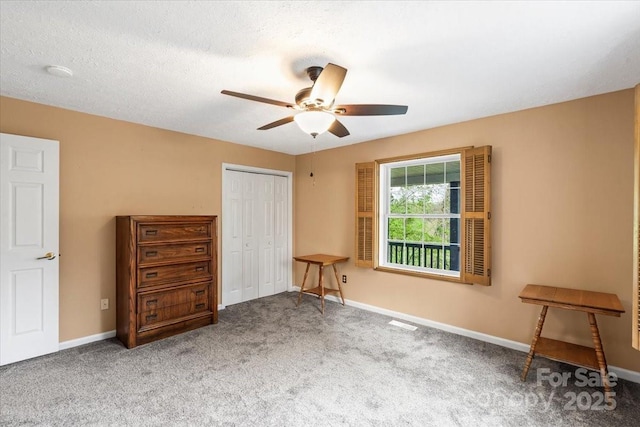 bedroom with ceiling fan, a closet, baseboards, and carpet floors
