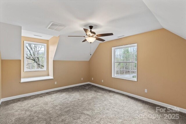 bonus room featuring lofted ceiling, visible vents, baseboards, and ceiling fan