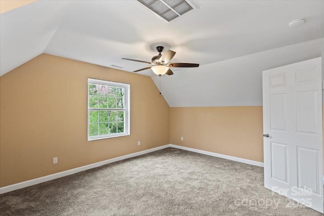 additional living space with visible vents, baseboards, a ceiling fan, carpet floors, and lofted ceiling