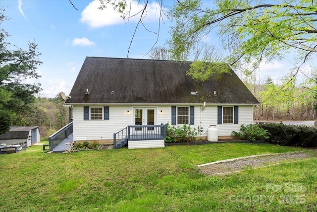 rear view of house with french doors and a yard