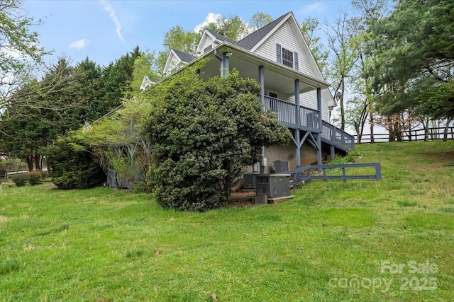 exterior space featuring a yard and stairs