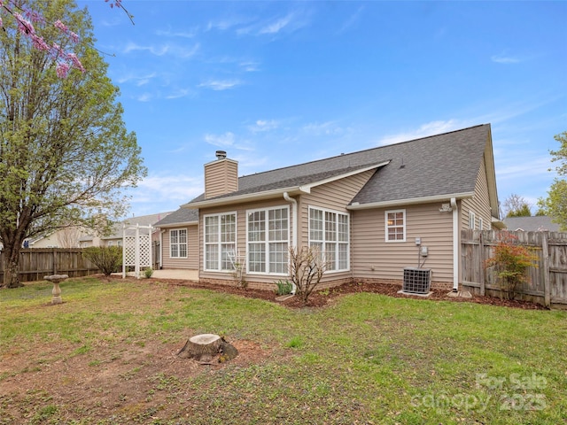 135 S Sunberry Trl, Fletcher, NC 28732 - rear view of property with a yard, a fenced backyard, a chimney, and a shingled roof