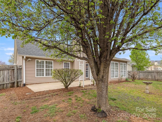 135 S Sunberry Trl, Fletcher, NC 28732 - rear view of property featuring a yard, a fenced backyard, a shingled roof, and a patio