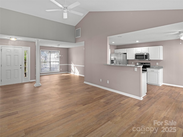 135 S Sunberry Trl, Fletcher, NC 28732 - unfurnished living room with decorative columns, a ceiling fan, visible vents, high vaulted ceiling, and light wood finished floors