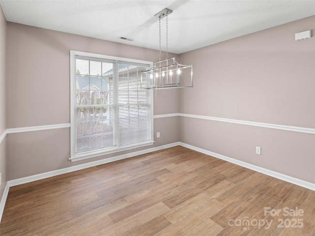 135 S Sunberry Trl, Fletcher, NC 28732 - unfurnished dining area with visible vents, baseboards, a notable chandelier, and light wood-style floors