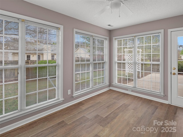 135 S Sunberry Trl, Fletcher, NC 28732 - unfurnished sunroom featuring baseboards, wood finished floors, and a textured ceiling