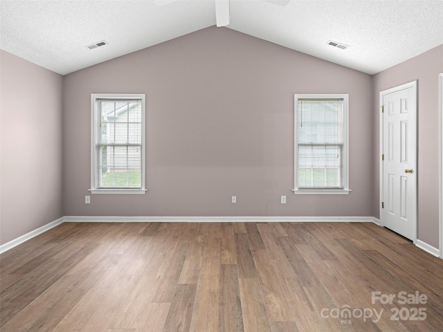 135 S Sunberry Trl, Fletcher, NC 28732 - unfurnished room with plenty of natural light, visible vents, wood finished floors, and lofted ceiling