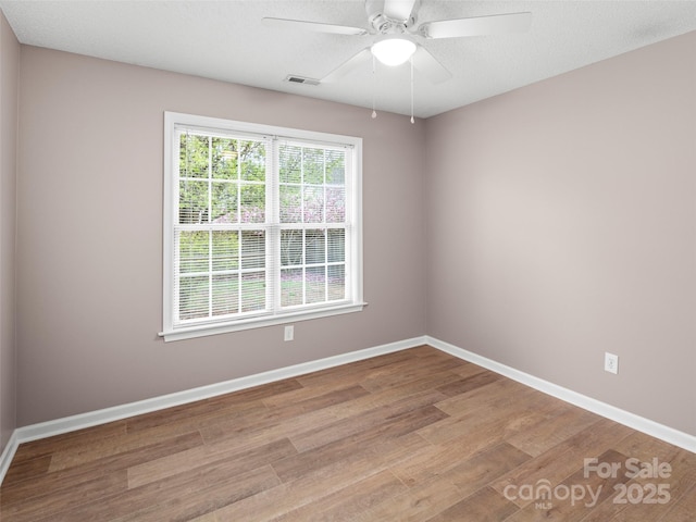 135 S Sunberry Trl, Fletcher, NC 28732 - empty room featuring wood finished floors, baseboards, a ceiling fan, and visible vents