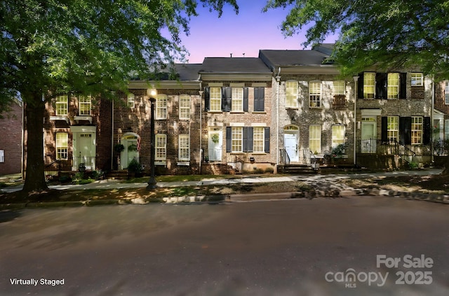 view of property with brick siding