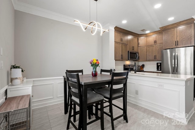 dining space with recessed lighting, a decorative wall, crown molding, and light tile patterned flooring