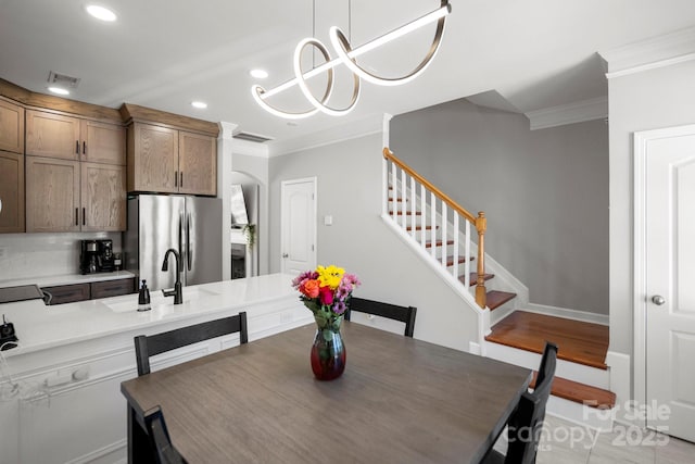 dining room featuring stairway, crown molding, visible vents, and recessed lighting