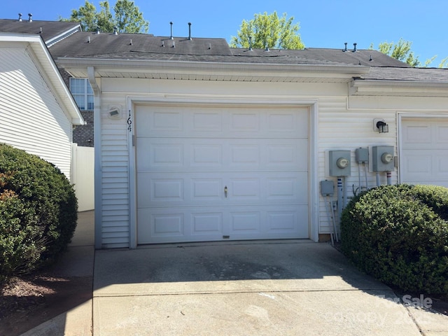 garage featuring concrete driveway
