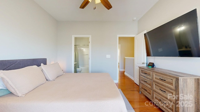 bedroom with light wood-style floors, a ceiling fan, and ensuite bathroom