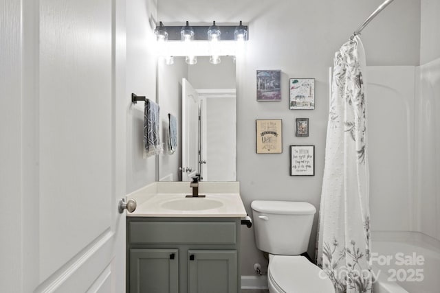 bathroom featuring toilet, vanity, and shower / bath combination with curtain