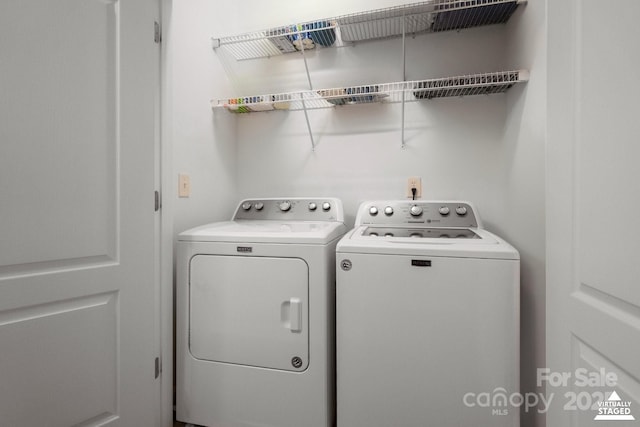 washroom featuring washer and clothes dryer and laundry area