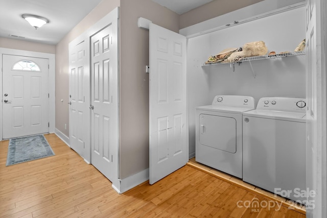 laundry area with independent washer and dryer, laundry area, visible vents, baseboards, and light wood-style floors