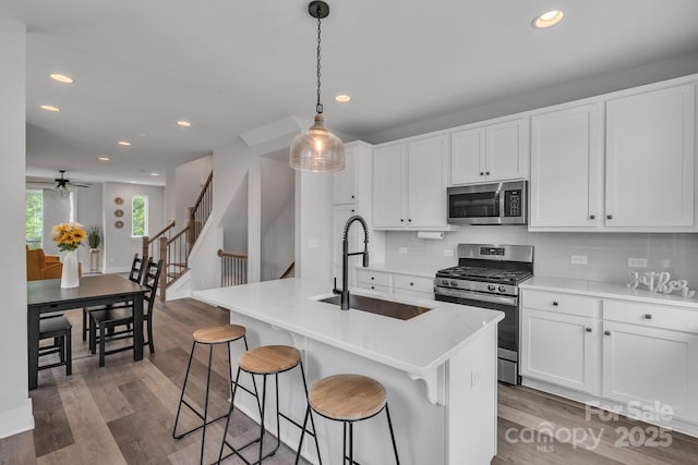 648 W End Dr, Charlotte, NC 28208 - kitchen featuring appliances with stainless steel finishes, a sink, recessed lighting, a ceiling fan, and decorative backsplash
