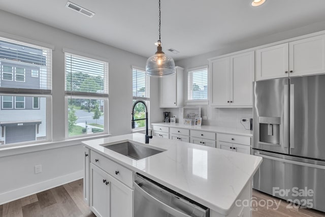 648 W End Dr, Charlotte, NC 28208 - kitchen featuring appliances with stainless steel finishes, a sink, healthy amount of natural light, wood finished floors, and recessed lighting