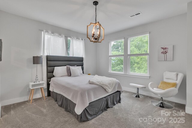 648 W End Dr, Charlotte, NC 28208 - bedroom featuring multiple windows, a chandelier, and carpet flooring