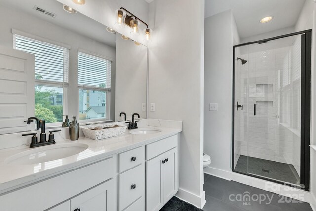 648 W End Dr, Charlotte, NC 28208 - bathroom featuring double vanity, toilet, tile patterned flooring, a shower stall, and recessed lighting
