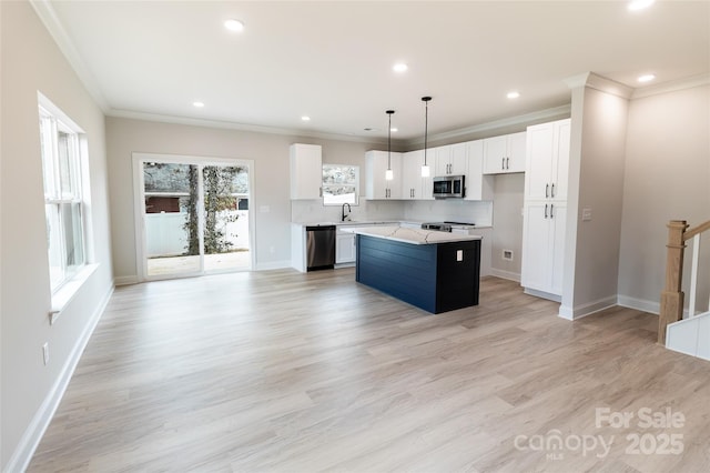 615 Billingsley Rd, Charlotte, NC 28211 - kitchen featuring ornamental molding, white cabinets, a center island, stainless steel appliances, and baseboards