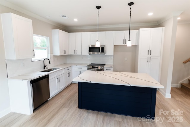 615 Billingsley Rd, Charlotte, NC 28211 - kitchen with a sink, light wood-type flooring, crown molding, stainless steel appliances, and backsplash