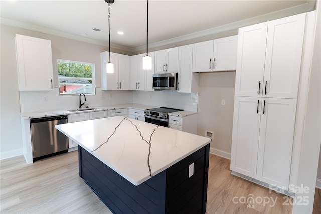 615 Billingsley Rd, Charlotte, NC 28211 - kitchen with a center island, a sink, stainless steel appliances, backsplash, and light stone counters
