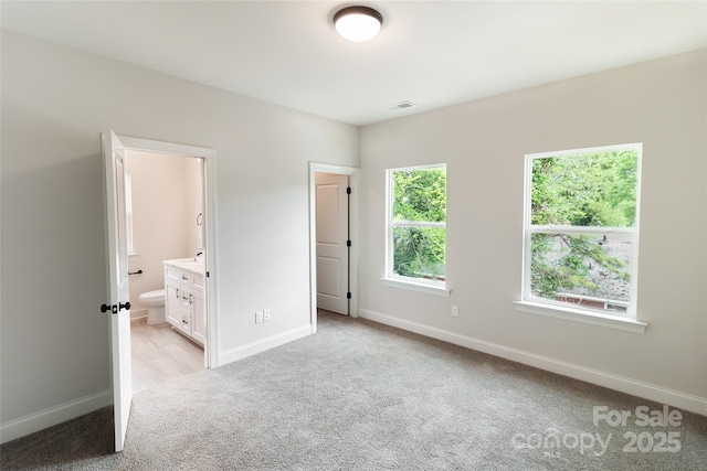 615 Billingsley Rd, Charlotte, NC 28211 - unfurnished bedroom with light carpet, ensuite bathroom, baseboards, and visible vents