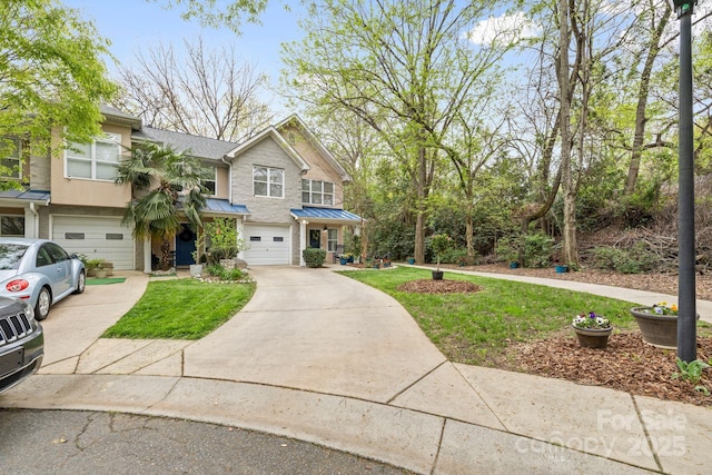view of front of home with a standing seam roof, a shingled roof, a garage, and driveway