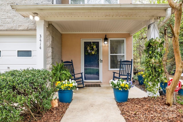 doorway to property featuring stucco siding