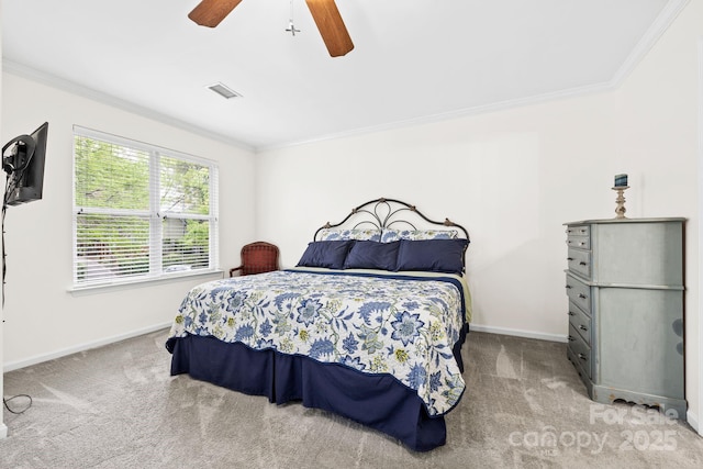 carpeted bedroom featuring crown molding, baseboards, and visible vents