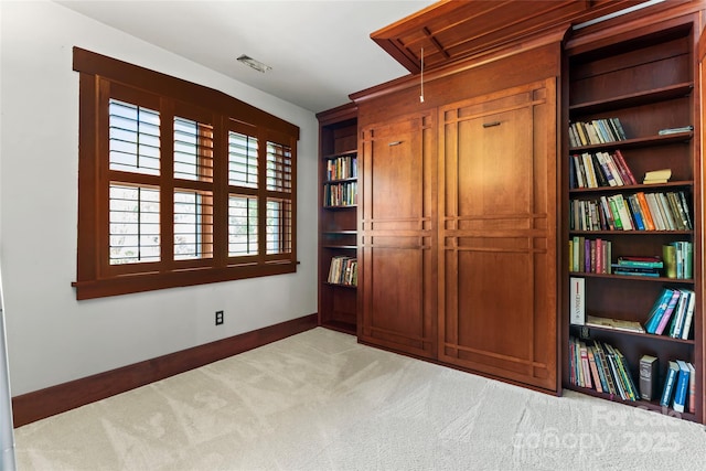 unfurnished bedroom with visible vents, baseboards, and carpet