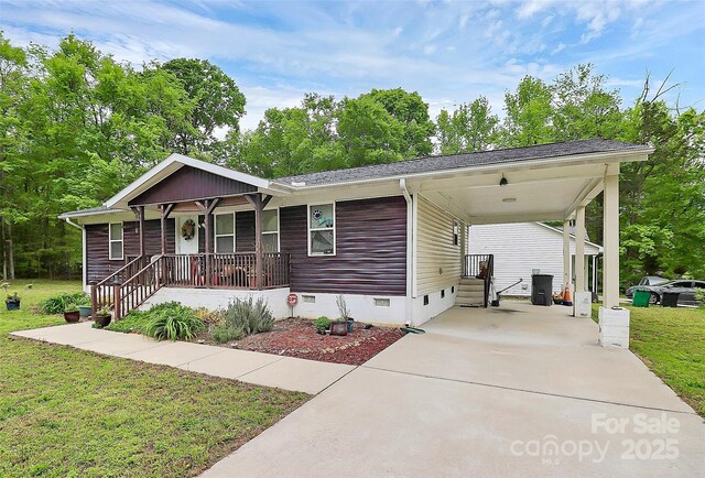 8301 Washington Blvd, Charlotte, NC 28262 - view of front of house with a porch, crawl space, a front lawn, an attached carport, and driveway